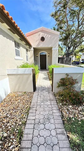 a front view of a house with a garden