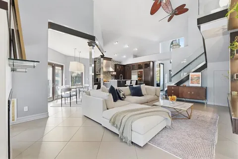 a kitchen with stainless steel appliances granite countertop a sink a stove and a wooden floors
