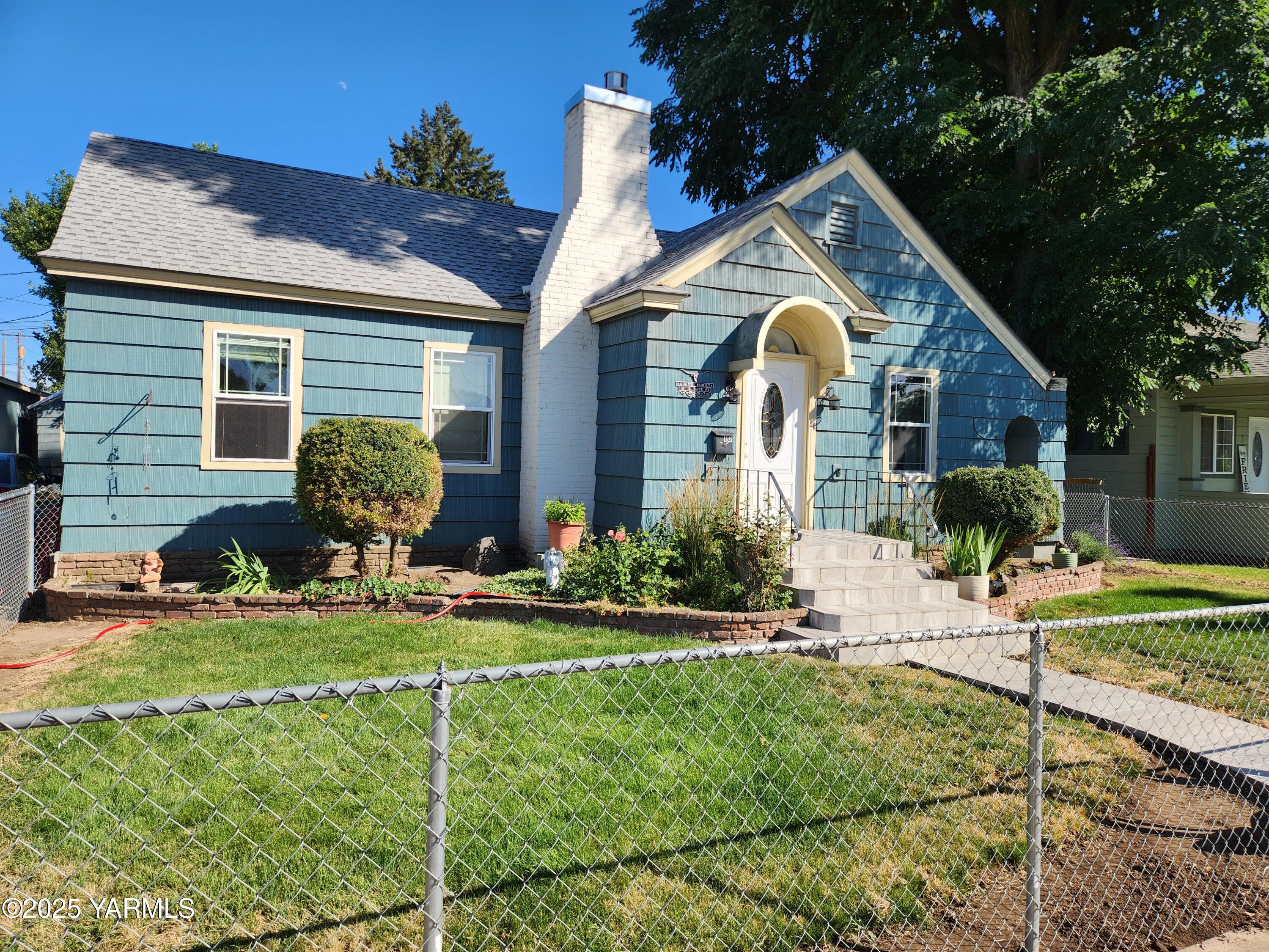 a front view of house with yard and green space
