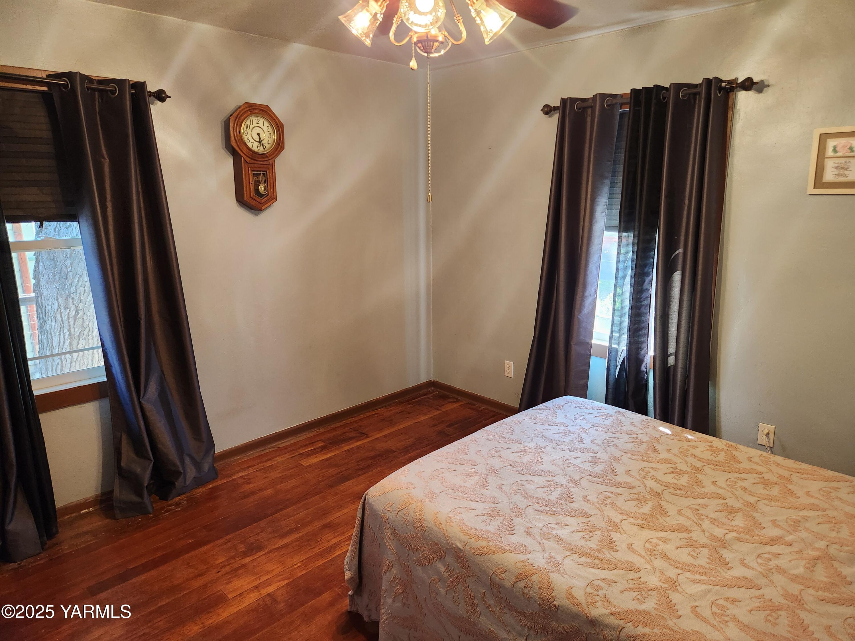 10 South Date Street Toppenish, WA 98948 - Photo 13 of 37 a bedroom with a bed and a chandelier