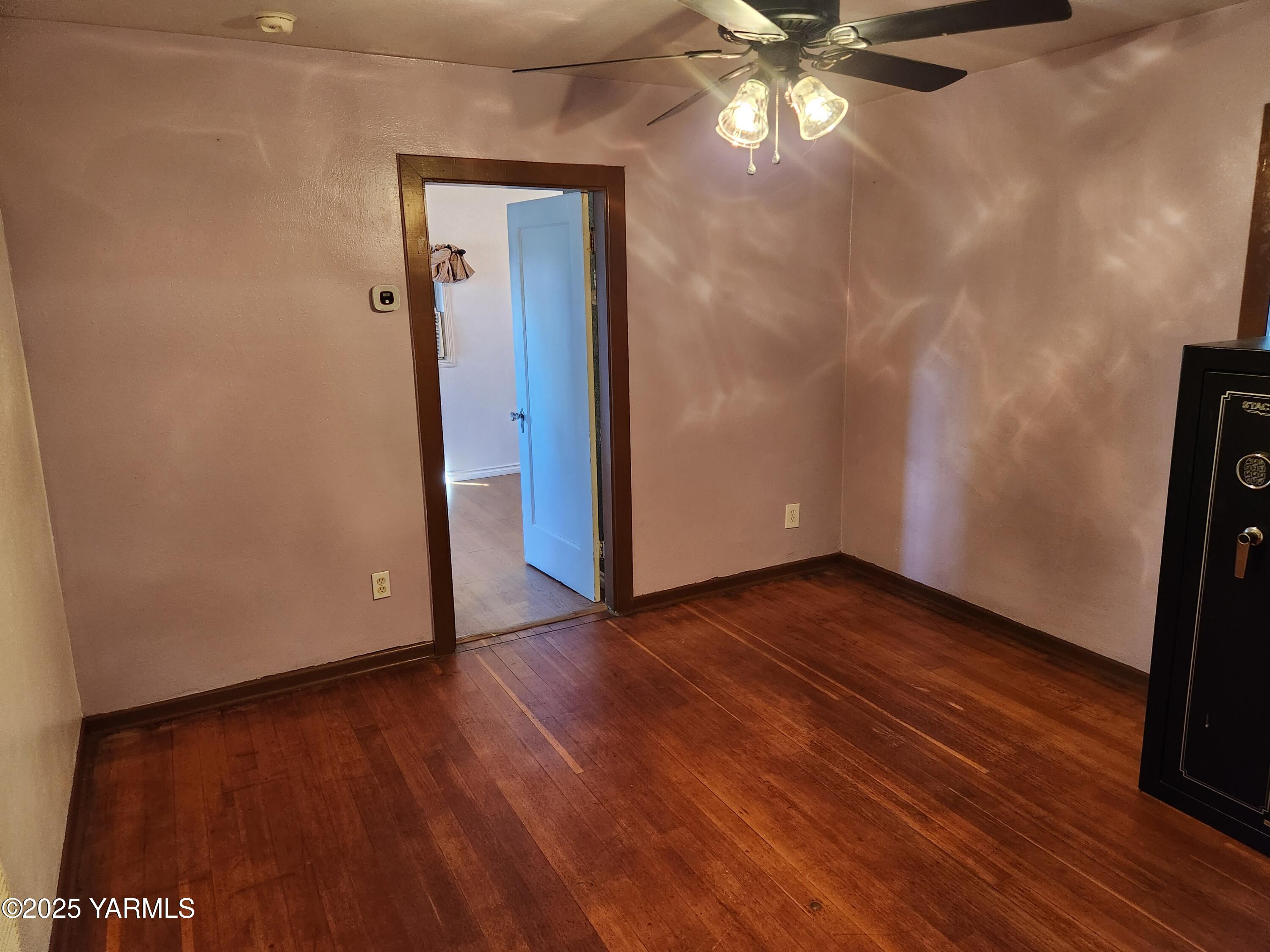 10 South Date Street Toppenish, WA 98948 - Photo 14 of 37 a view of an empty room with wooden floor and a window