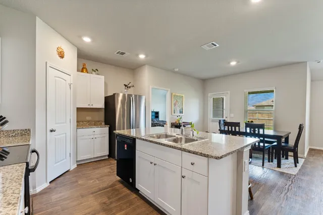 a kitchen with refrigerator and cabinets