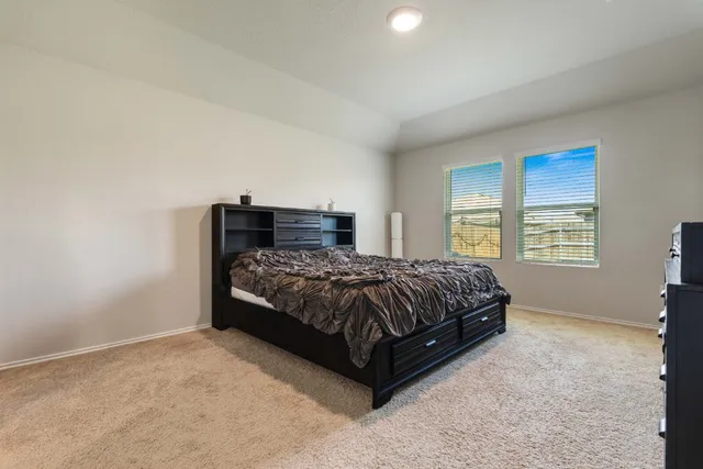 a bedroom with a bed and window