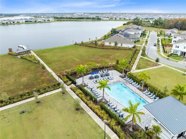 an aerial view of a house with a lake view