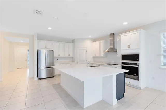 a kitchen with stainless steel appliances a refrigerator sink and cabinets
