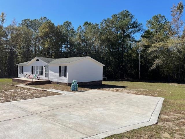 6640 Muscat Road Hope Mills, NC 28348 - Photo 12 of 22 a view of a white house with a yard