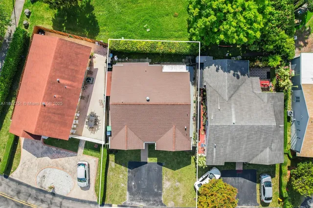 a view of backyard of house garage with green space