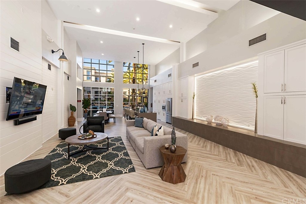 1326 Scholarship Irvine, CA 92612 - Photo 14 of 22 a living room with furniture a flat screen tv and a floor to ceiling window