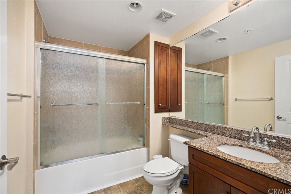 1326 Scholarship Irvine, CA 92612 - Photo 9 of 22 a bathroom with a granite countertop sink toilet and shower