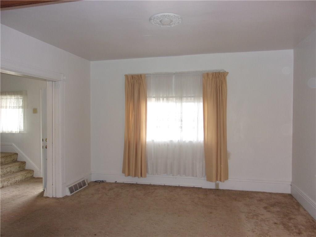 3 Maple Street Trafford, PA 15085 - Photo 3 of 24 Spacious, bright living room with high ceilings and hardwood floors beneath carpet.