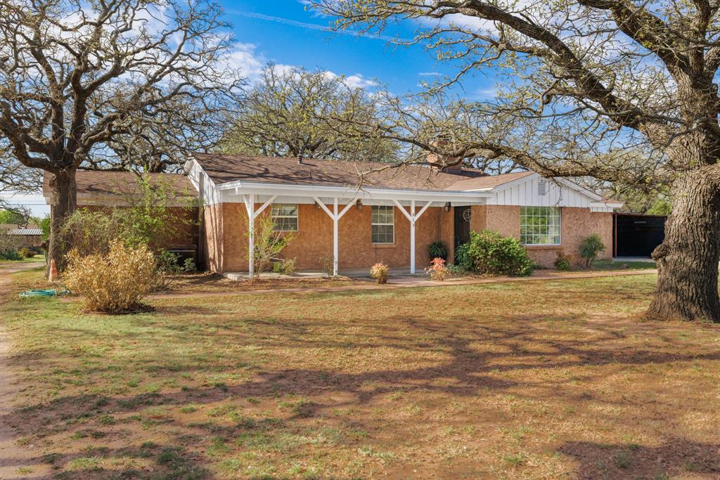 513 Sandy Lane Clyde, TX 79510 - Photo 1 of 1 a front view of a house with a garden