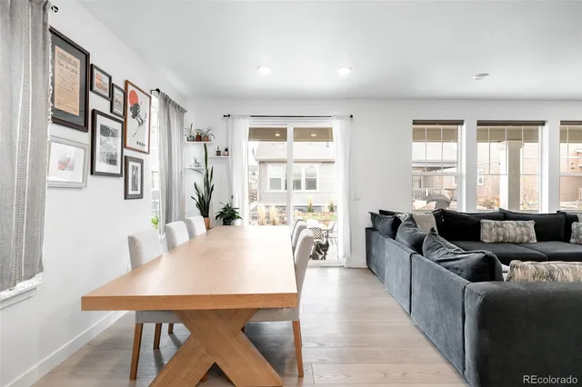 a living room with furniture and large windows