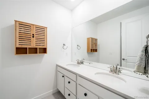 a bathroom with a double vanity sink and mirror