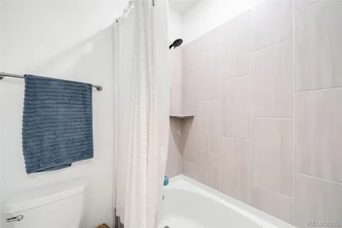 a bathroom with a bathtub and shower