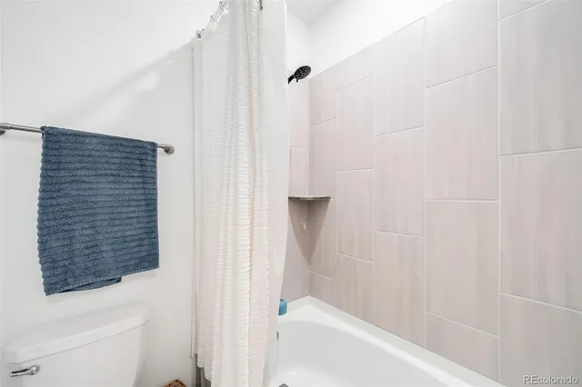 a bathroom with a bathtub and shower