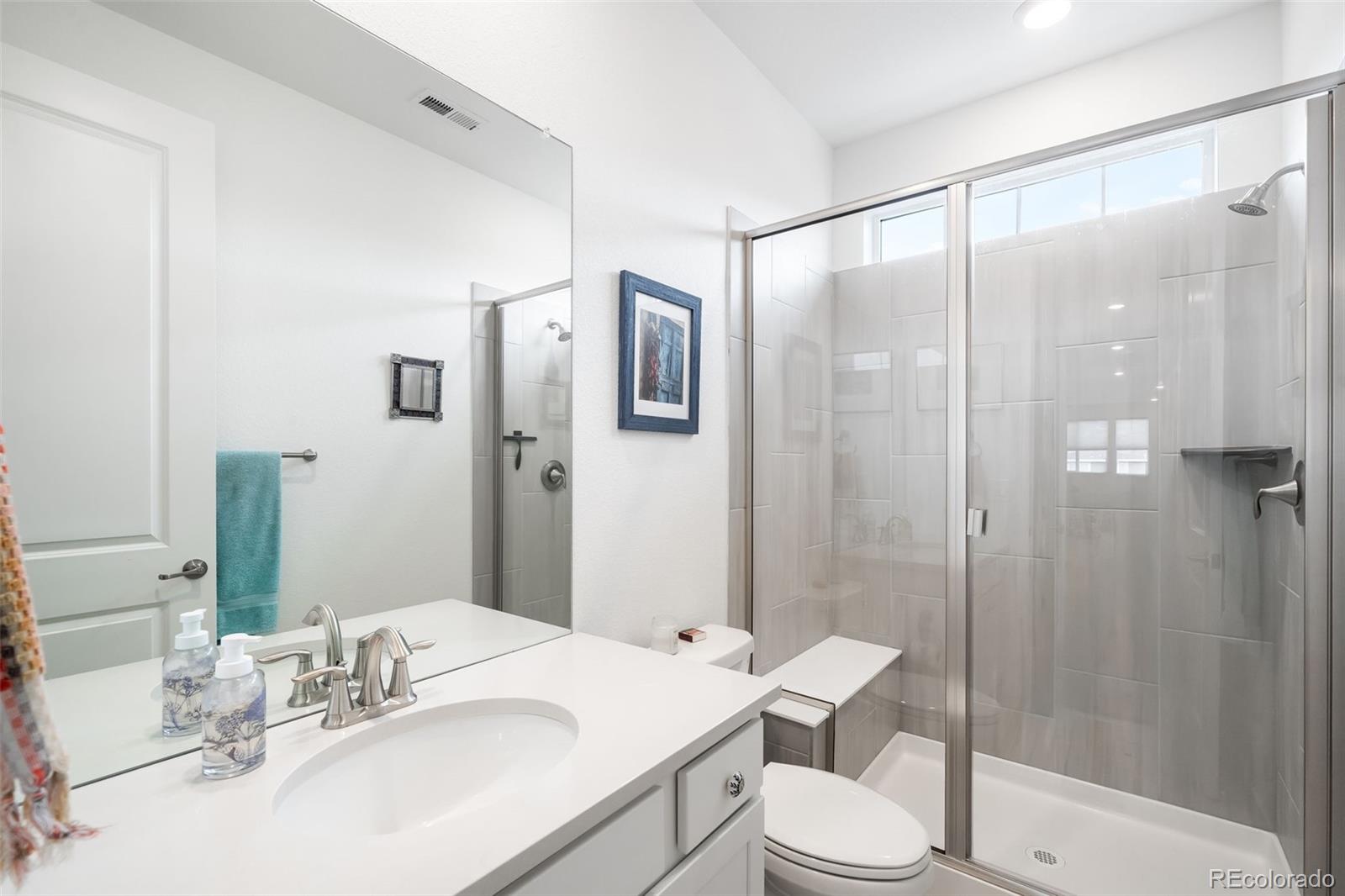 1928 Marlowe Circle West Erie, CO 80516 - Photo 24 of 47 a bathroom with a sink toilet and shower
