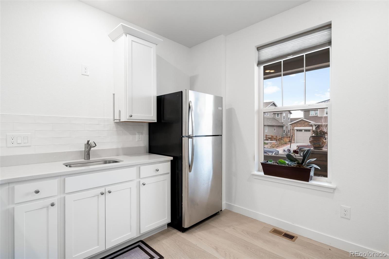 1928 Marlowe Circle West Erie, CO 80516 - Photo 29 of 47 a kitchen with a refrigerator and a sink