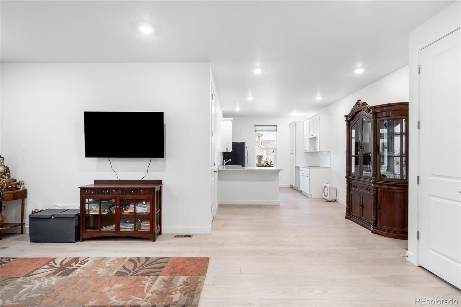 1928 Marlowe Circle West Erie, CO 80516 - Photo 31 of 47 a living room with furniture and a flat screen tv