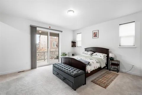 a spacious bedroom with a bed couch and a window