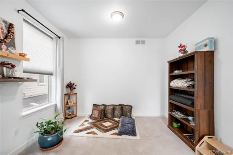 a living room with furniture and book shelf