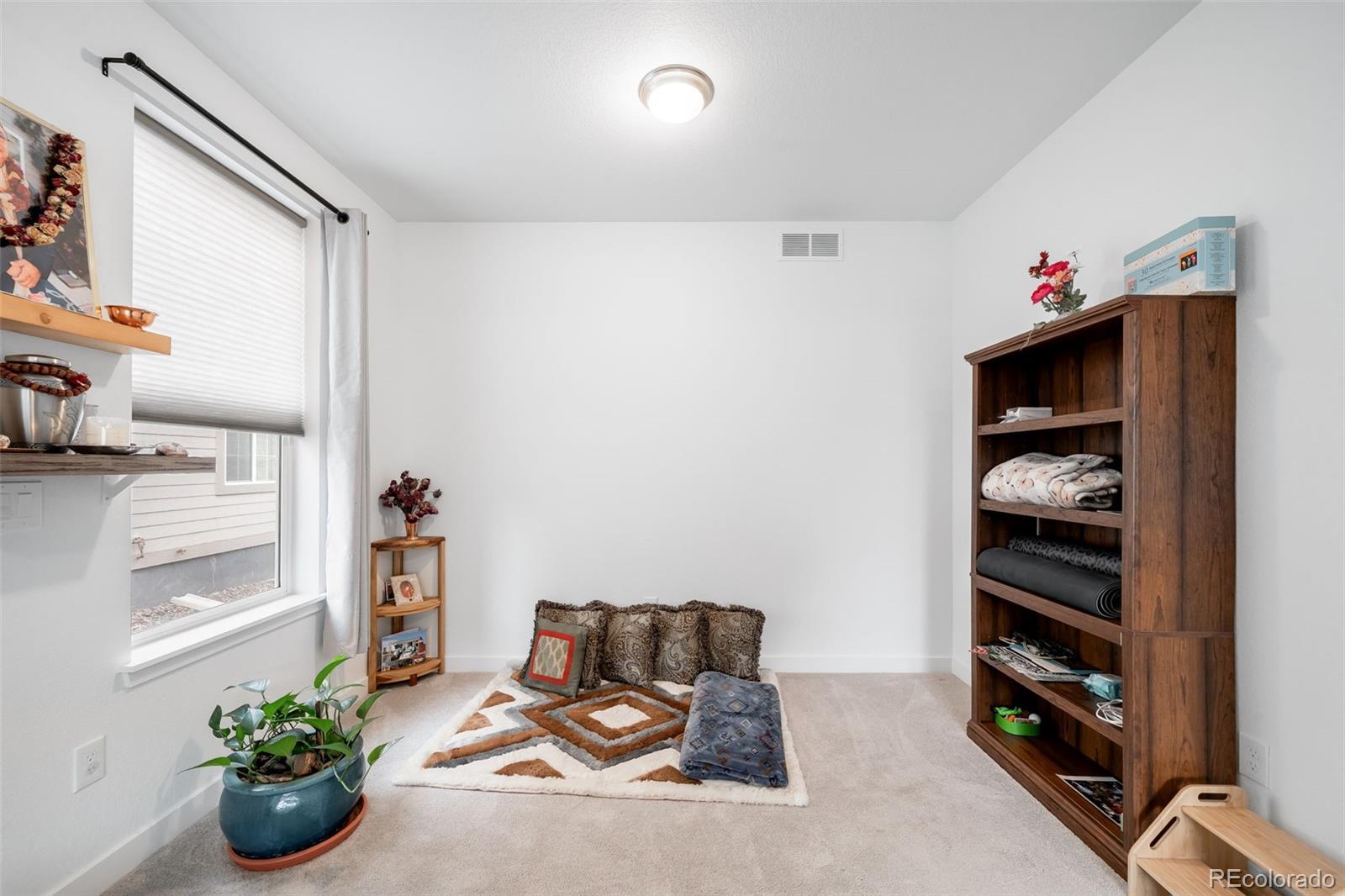 1928 Marlowe Circle West Erie, CO 80516 - Photo 34 of 47 a living room with furniture and book shelf