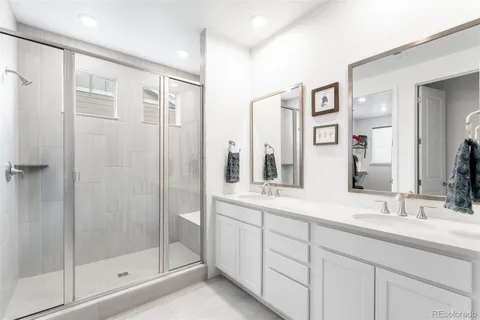 a bathroom with a shower sink and mirror