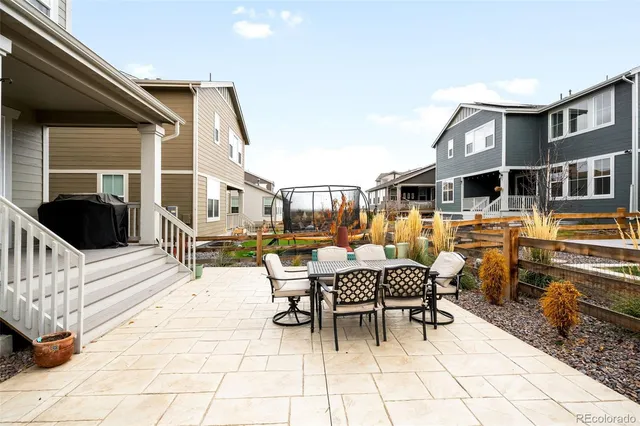 a view of a patio with a dining table and chairs with wooden floor