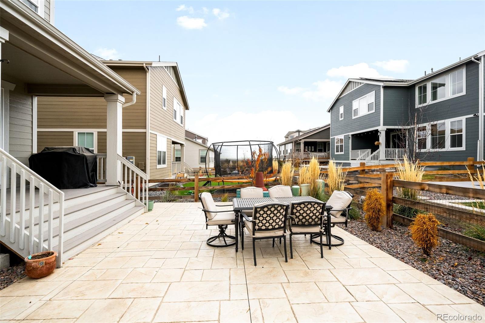 1928 Marlowe Circle West Erie, CO 80516 - Photo 41 of 47 a view of a patio with a dining table and chairs with wooden floor