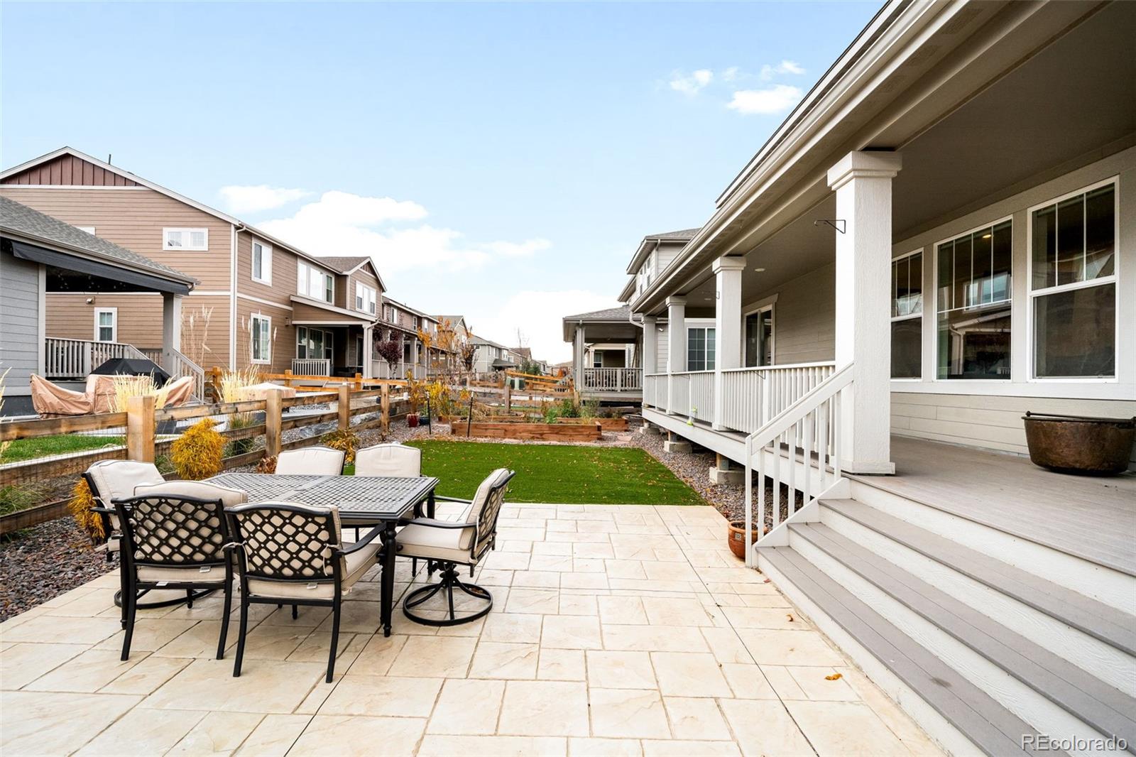 1928 Marlowe Circle West Erie, CO 80516 - Photo 42 of 47 a view of a patio with dining table and chairs with a barbeque grill and plants