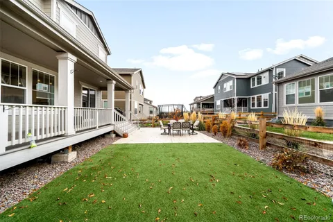 a view of a house with backyard and porch