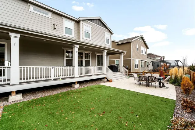 a view of a house with a deck and a yard