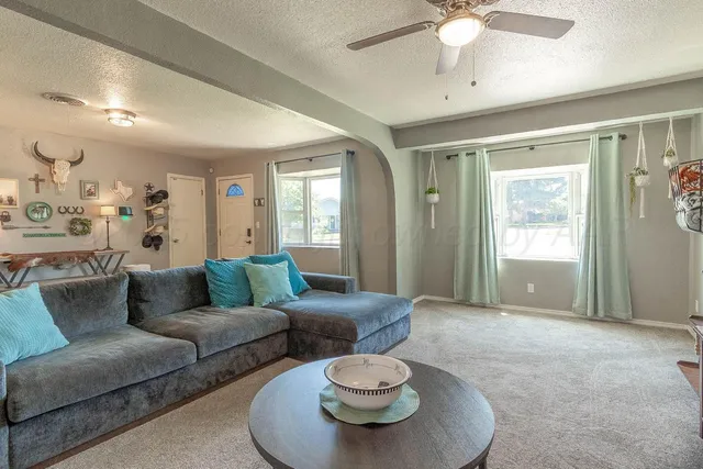 a living room with furniture and a large window