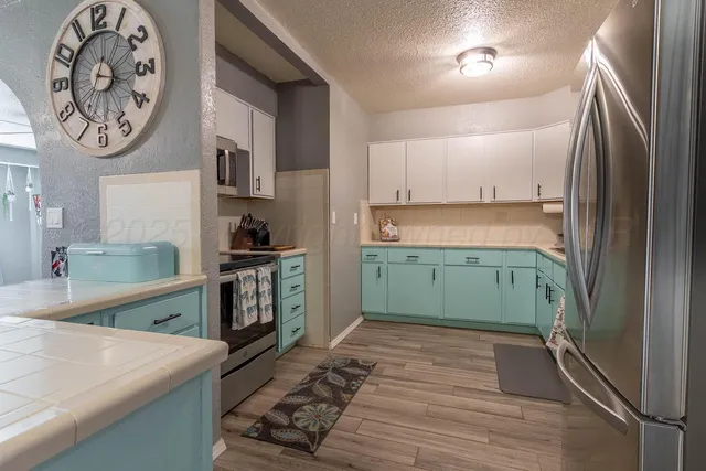 a kitchen with a refrigerator and a sink