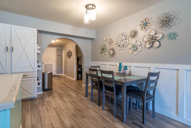 a view of a dining room with furniture and wooden floor