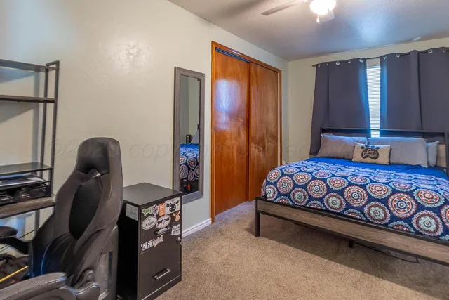 a bedroom with a bed and a dresser