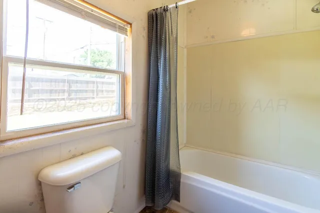 a bathroom with a shower and a toilet