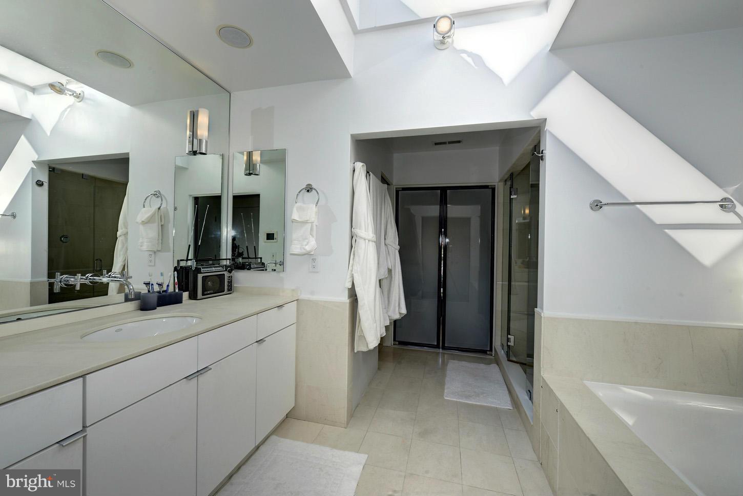 3618 Prospect Street Northwest Washington, DC 20007 - Photo 20 of 30 a bathroom with a double vanity sink a mirror and a bathtub