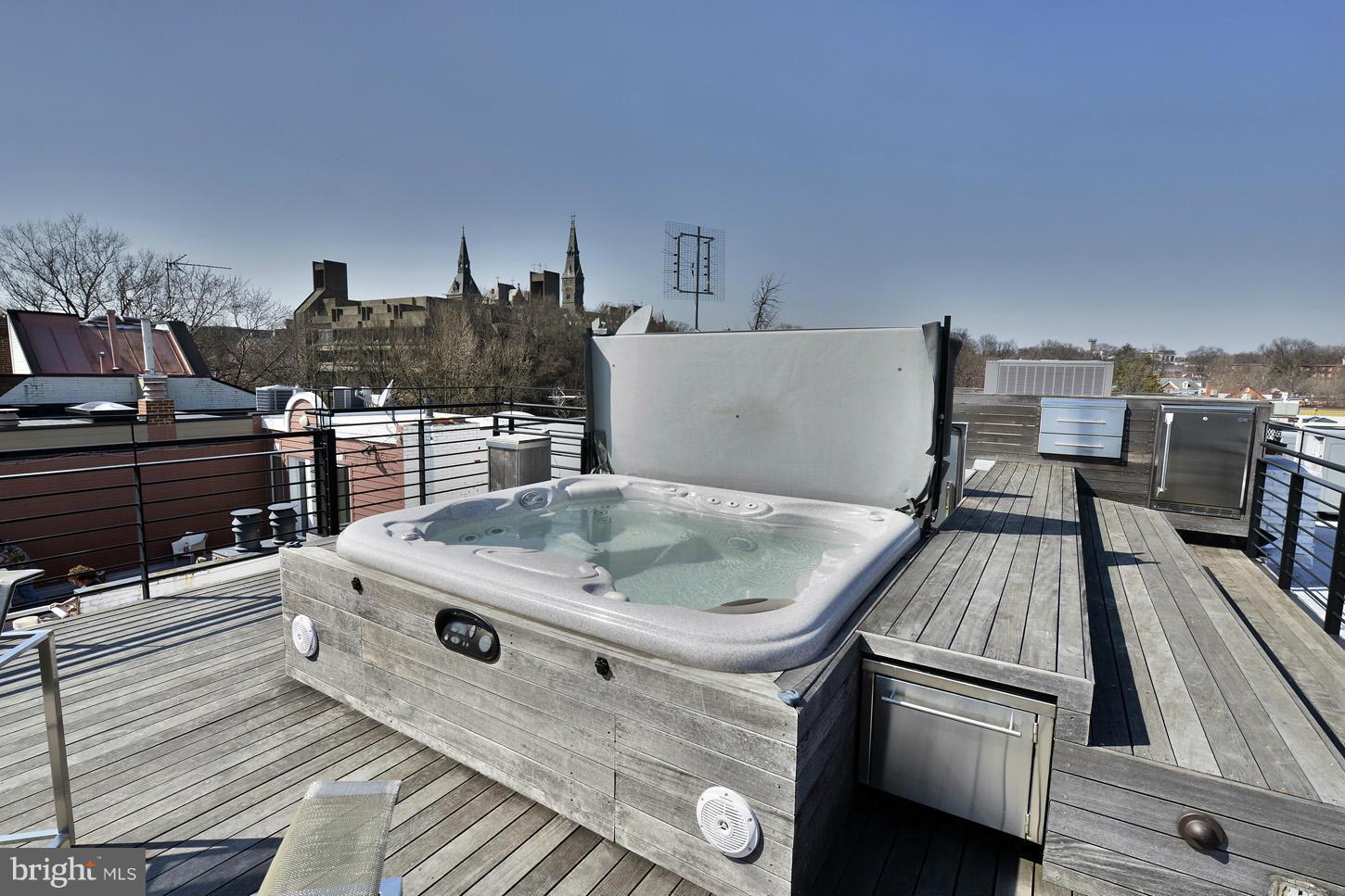 3618 Prospect Street Northwest Washington, DC 20007 - Photo 25 of 30 a view of a kitchen with kitchen island a stove a chimney a sink and dishwasher a oven with wooden floor