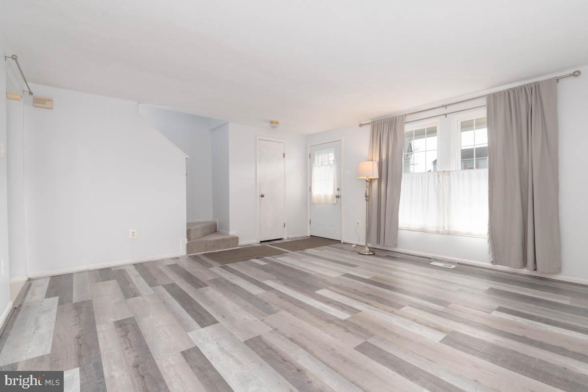 1312 Acorn Ridge Court Edgewood, MD 21040 - Photo 5 of 39 a view of an empty room with wooden floor and a window