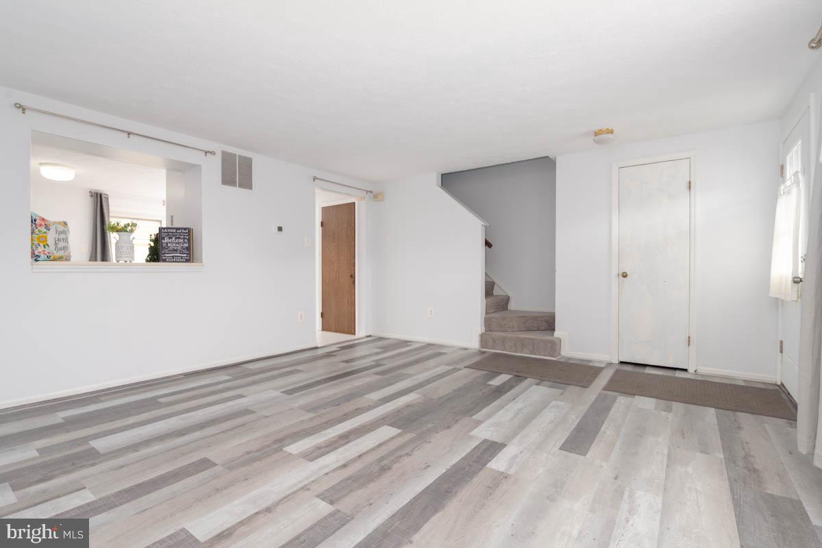 1312 Acorn Ridge Court Edgewood, MD 21040 - Photo 7 of 39 a view of an empty room with wooden floor and a window
