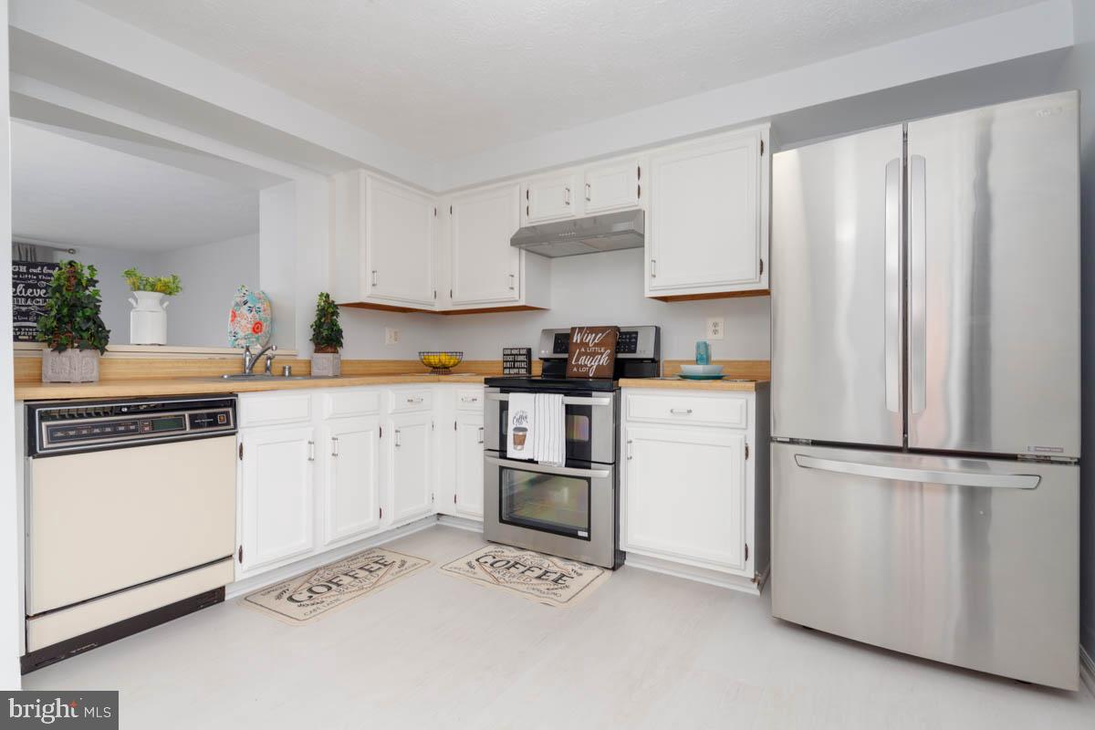 1312 Acorn Ridge Court Edgewood, MD 21040 - Photo 10 of 39 a kitchen with white cabinets and white appliances