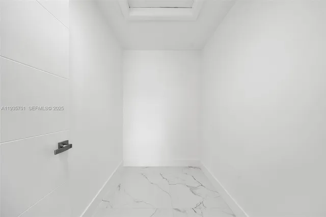 an empty room with ceiling fan and window