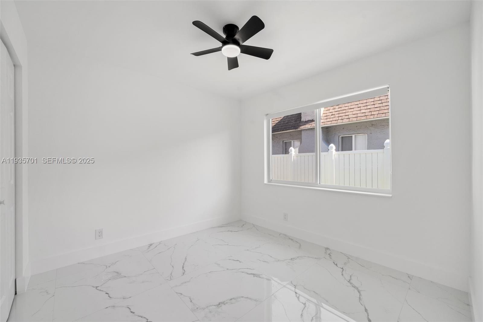 253 Southwest 4th Street Dania Beach, FL 33004 - Photo 12 of 27 an empty room with ceiling fan and window