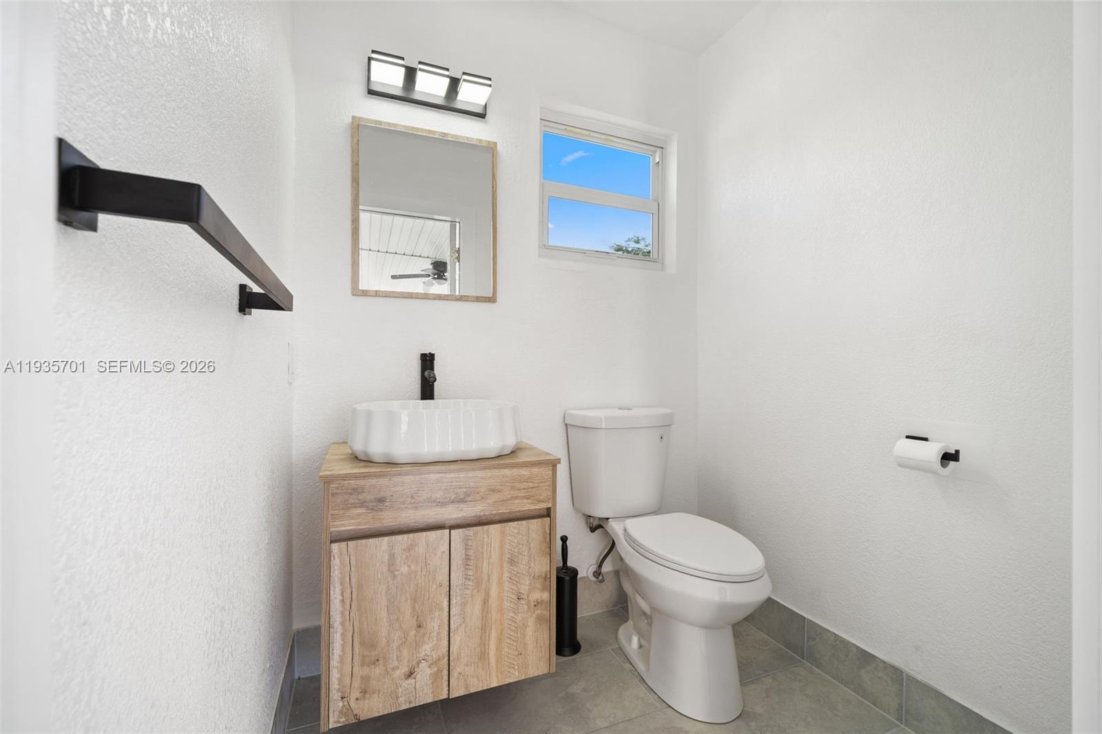 253 Southwest 4th Street Dania Beach, FL 33004 - Photo 21 of 27 a bathroom with a toilet a sink and mirror