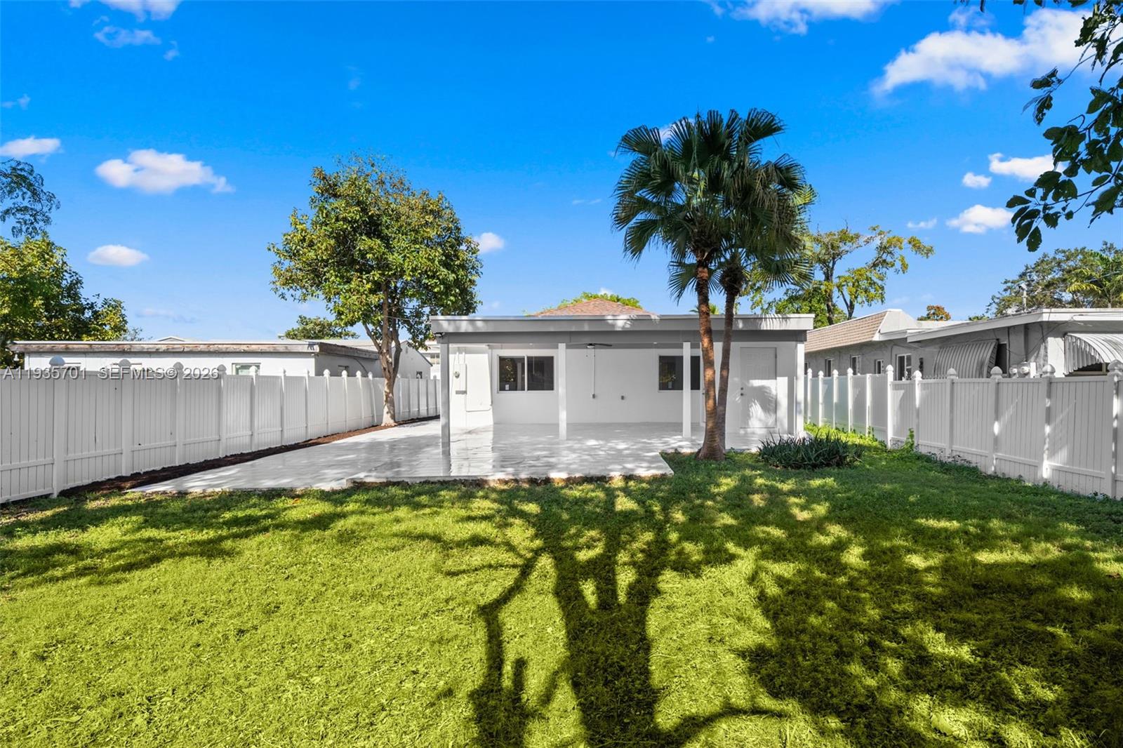 253 Southwest 4th Street Dania Beach, FL 33004 - Photo 24 of 27 a view of a house with wooden fence and a large tree