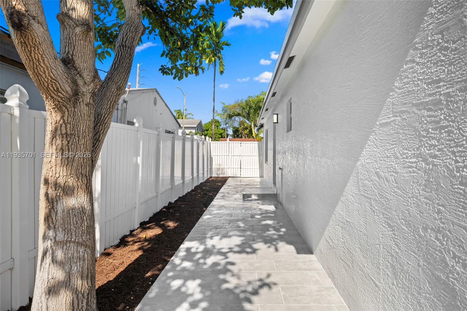 253 Southwest 4th Street Dania Beach, FL 33004 - Photo 26 of 27 a view of a pathway of a house with wooden fence