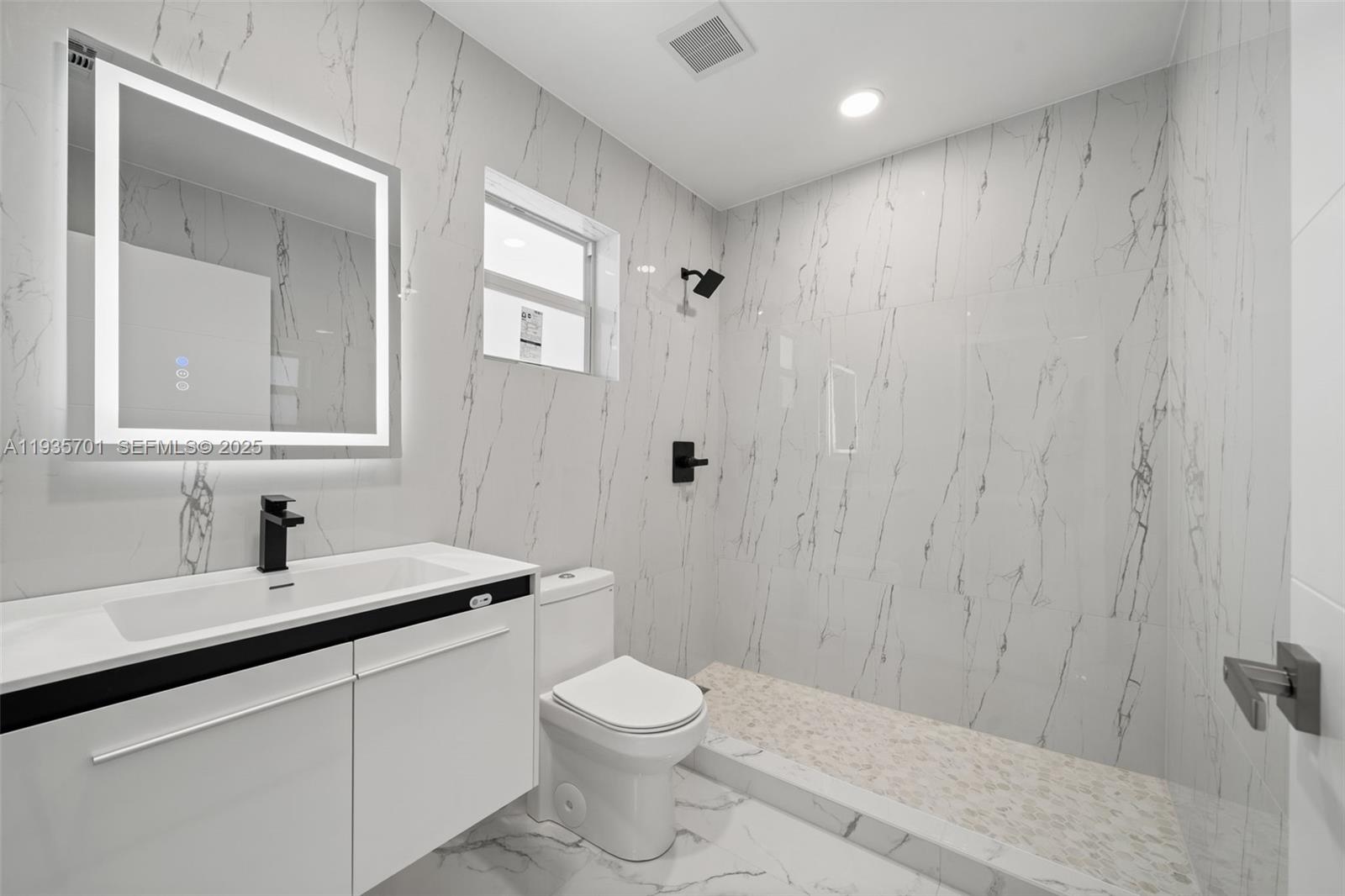 253 Southwest 4th Street Dania Beach, FL 33004 - Photo 9 of 27 a bathroom with a sink a toilet and shower