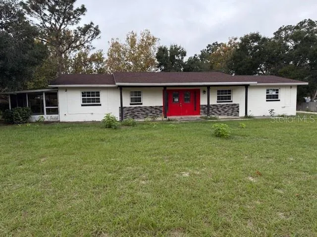 a view of a house with a yard and a garage