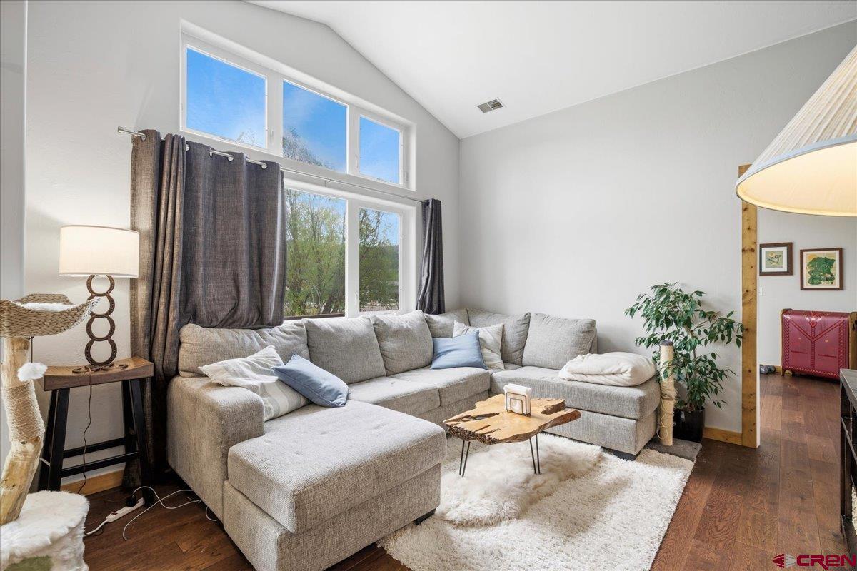 520 Redcliff Circle, Unit G203 Ridgway, CO 81432 - Photo 2 of 25 a living room with furniture a large window and wooden floor