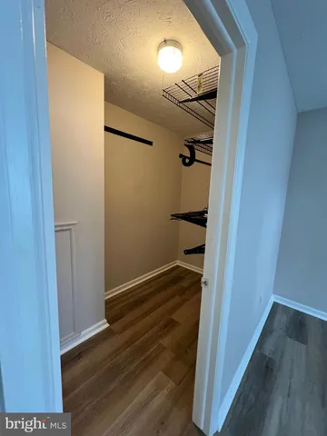 a view of hallway with wooden floor